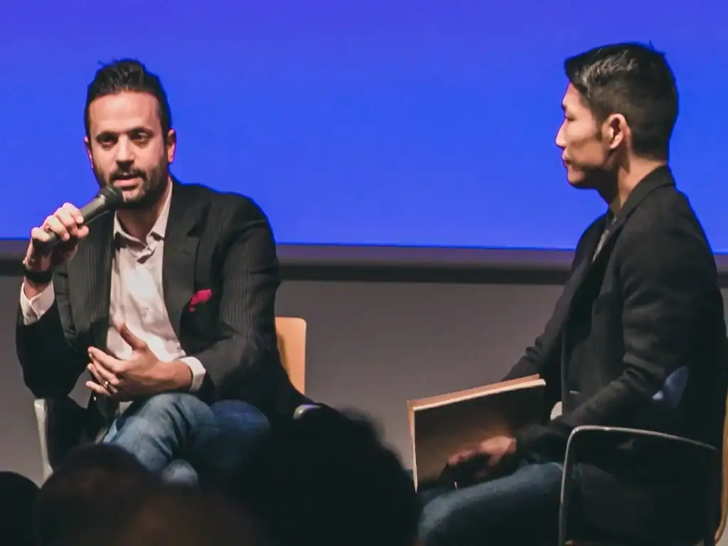Senior leader collaborating with creative professionals in a modern workspace — illustrating how creative leadership requires adapting management style to support designers, artists, and strategists